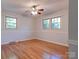 Bright bedroom with hardwood floors, two windows, neutral walls, and a ceiling fan at 113 Princess Ln, Dallas, NC 28034
