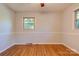 Inviting bedroom featuring hardwood floors, neutral walls, and a window for natural light, creating a cozy retreat at 113 Princess Ln, Dallas, NC 28034