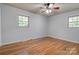 Bedroom featuring hardwood floors, neutral walls, two windows, and ceiling fan at 113 Princess Ln, Dallas, NC 28034