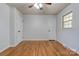 Bedroom featuring hardwood floors, neutral walls, two doors, one window, and ceiling fan at 113 Princess Ln, Dallas, NC 28034
