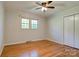 Bedroom featuring hardwood floors, neutral walls, closet, two windows, and ceiling fan at 113 Princess Ln, Dallas, NC 28034