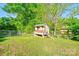 Outdoor chicken coop in yard, with fencing and natural setting at 113 Princess Ln, Dallas, NC 28034