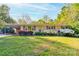 Charming brick home with mature landscaping and a spacious front yard at 113 Princess Ln, Dallas, NC 28034