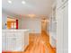 Open concept kitchen with white cabinets, stainless steel appliances, and hardwood floors at 113 Princess Ln, Dallas, NC 28034