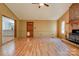 Open living room with hardwood floors, featuring a fireplace and an entry door, with an open view to the kitchen at 113 Princess Ln, Dallas, NC 28034
