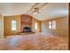 Spacious living room with a vaulted ceiling, brick fireplace, and large windows offering abundant natural light at 113 Princess Ln, Dallas, NC 28034