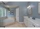 Stylish bathroom featuring a soaking tub, double vanity, and neutral tile flooring at 1202 Foxfield Rd, Waxhaw, NC 28173
