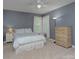 Bright bedroom with natural light, neutral carpet, and a side table with lamp at 1202 Foxfield Rd, Waxhaw, NC 28173