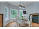 Cozy breakfast nook with a round table, white chairs, and views of the green backyard at 1202 Foxfield Rd, Waxhaw, NC 28173