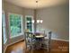 Bright dining area featuring a wooden table, chairs, and a chandelier near a window at 1202 Foxfield Rd, Waxhaw, NC 28173