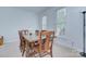 Bright dining room with large wooden table, seating, and ample natural light at 1202 Foxfield Rd, Waxhaw, NC 28173
