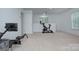 Spacious exercise room with carpet flooring and multiple windows providing natural light at 1202 Foxfield Rd, Waxhaw, NC 28173