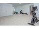 Large exercise room featuring carpet flooring, ample natural light, and various workout equipment at 1202 Foxfield Rd, Waxhaw, NC 28173
