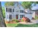 Charming white two-story home with black shutters, well-maintained lawn and brick-lined driveway at 1202 Foxfield Rd, Waxhaw, NC 28173