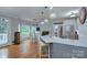 Open-concept kitchen featuring stainless steel appliances, granite countertops, and eat-in bar at 1202 Foxfield Rd, Waxhaw, NC 28173