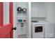 Functional laundry room with modern washer and dryer, shelving, and ample storage at 1202 Foxfield Rd, Waxhaw, NC 28173