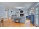 Open living room featuring a fireplace, hardwood floors, and access to other living areas at 1202 Foxfield Rd, Waxhaw, NC 28173