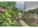 Landscaped yard with a charming flower-lined path and gate leading to the property at 1202 Foxfield Rd, Waxhaw, NC 28173