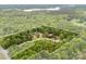 An aerial view of property lines outlined in white, nestled among lush trees near a lake at 124 Neumann Run, Belmont, NC 28012