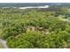 Aerial view of the home surrounded by lush trees with a gravel road leading up to it at 124 Neumann Run, Belmont, NC 28012