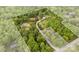 Expansive wooded acreage outlined, revealing a serene homesite with winding drive and natural beauty at 124 Neumann Run, Belmont, NC 28012