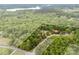 An aerial view with white outlines showing property lines, surrounded by lush trees at 124 Neumann Run, Belmont, NC 28012