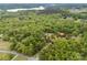 Aerial view of the home surrounded by lush trees with a gravel road leading up to it at 124 Neumann Run, Belmont, NC 28012
