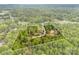 Wooded acreage outlined on the aerial view, showcasing a private home site with mature trees and secluded driveway at 124 Neumann Run, Belmont, NC 28012
