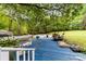 View of the backyard deck overlooking the expansive yard and mature trees at 124 Neumann Run, Belmont, NC 28012