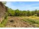 An exterior shot shows a field and the side of a rustic barn at 124 Neumann Run, Belmont, NC 28012