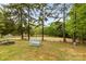 Serene backyard view of a horse arena featuring white fencing and mature shade trees at 124 Neumann Run, Belmont, NC 28012