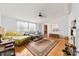 Inviting living room featuring hardwood floors, a ceiling fan, and abundant natural light at 124 Neumann Run, Belmont, NC 28012