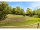 The lot offers a mix of open space and mature trees, creating a versatile outdoor haven at 124 Neumann Run, Belmont, NC 28012