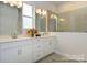 Modern bathroom boasts double vanity, quartz countertops, framed mirrors, and a walk-in shower at 1334 Idyllic Ln, Waxhaw, NC 28173