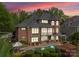 Back exterior view showcasing a pool, deck, and lush landscaping ideal for relaxing and entertaining at 13420 Robert Walker Dr, Davidson, NC 28036