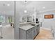 Modern basement bar area with gray cabinetry, granite countertops, and a full sink for added convenience at 13420 Robert Walker Dr, Davidson, NC 28036
