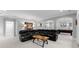 Finished basement with a large black leather sectional sofa and a pool table in the background at 13420 Robert Walker Dr, Davidson, NC 28036