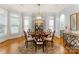 Formal dining room features a decorative chandelier, hardwood floors, and natural light at 13420 Robert Walker Dr, Davidson, NC 28036
