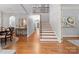 Bright foyer with hardwood floors and staircase with wood and iron handrail at 13420 Robert Walker Dr, Davidson, NC 28036