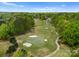 Aerial view of a lush golf course with mature trees, sand traps, and winding cart paths at 13420 Robert Walker Dr, Davidson, NC 28036