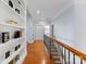 Hallway with hardwood floors, decorative shelving, and elegant staircase leading to the next level at 13420 Robert Walker Dr, Davidson, NC 28036