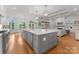 Open floor plan shows modern island kitchen leading into the living and dining areas at 13420 Robert Walker Dr, Davidson, NC 28036