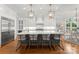 A gourmet kitchen features white cabinets, stainless appliances, and a large center island at 13420 Robert Walker Dr, Davidson, NC 28036