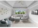 Bright living room boasts a vaulted ceiling, large windows, and comfortable gray sectional sofa at 13420 Robert Walker Dr, Davidson, NC 28036