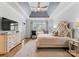 Comfortable primary bedroom with tray ceiling, an ensuite bathroom, and natural light at 13420 Robert Walker Dr, Davidson, NC 28036