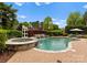 Backyard pool and spa area featuring waterfall and a well manicured landscape at 13420 Robert Walker Dr, Davidson, NC 28036