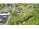 Aerial view showcasing the property's layout, lush greenery, surrounding neighborhood and proximity to a main road at 15 Willow Oaks Ct, Taylorsville, NC 28681
