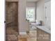 Neutral bathroom with tiled walk-in shower, vanity, and window at 15 Willow Oaks Ct, Taylorsville, NC 28681