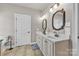 Bathroom features a double sink vanity, framed mirrors, and tiled floors at 15 Willow Oaks Ct, Taylorsville, NC 28681