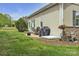 Back patio featuring outdoor dining set, grill, flower pot, and garden hose for a relaxing outdoor experience at 15 Willow Oaks Ct, Taylorsville, NC 28681